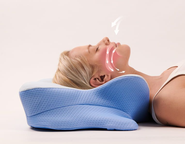 Side view of a woman resting her head and neck on Derila Ergo